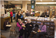 Patrons attending a wine and cheese social at the public library