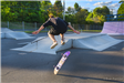 Youth doing skateboard trick at skate park