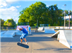 Youth riding skateboards and bicycles at skate park