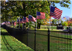 Perimeter fence along Iwo Jima Memorial Park depicting United States of America flag