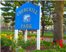 Sign at entrance to Churchill Park depicting flowers near base