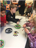 children making pipe cleaner spider crafts