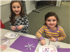 girls making pipe cleaner beaded snowflakes