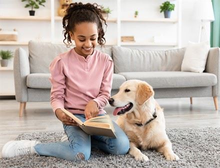 Tales to Tails girl reading to dog