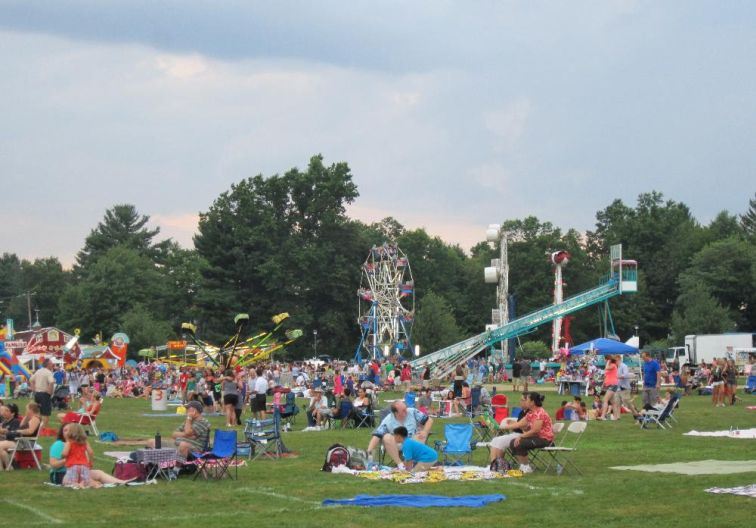 Grass Area at Mill Pond park with carnival rides in the background
