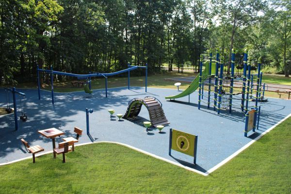 Blue and green playground overview. There are sings and multiple slides.