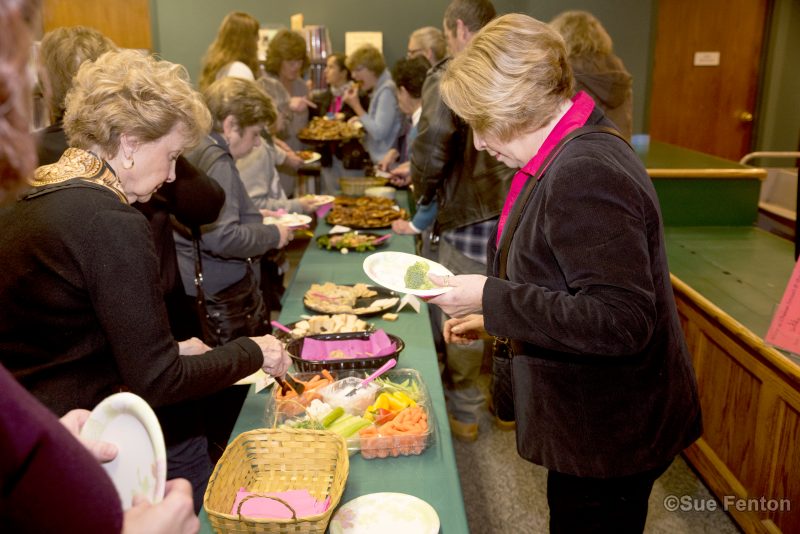 Patrons attending a wine and cheese social at the public library