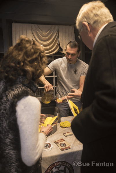 Patrons attending a wine and cheese social at the public library