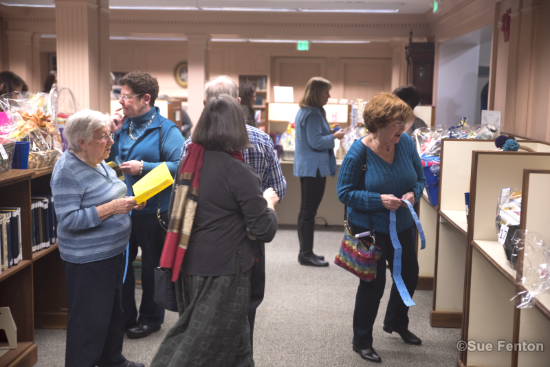 Patrons attending a wine and cheese social at the public library