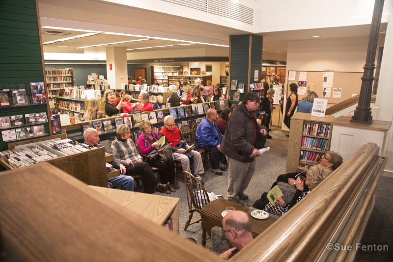 Patrons attending a wine and cheese social at the public library