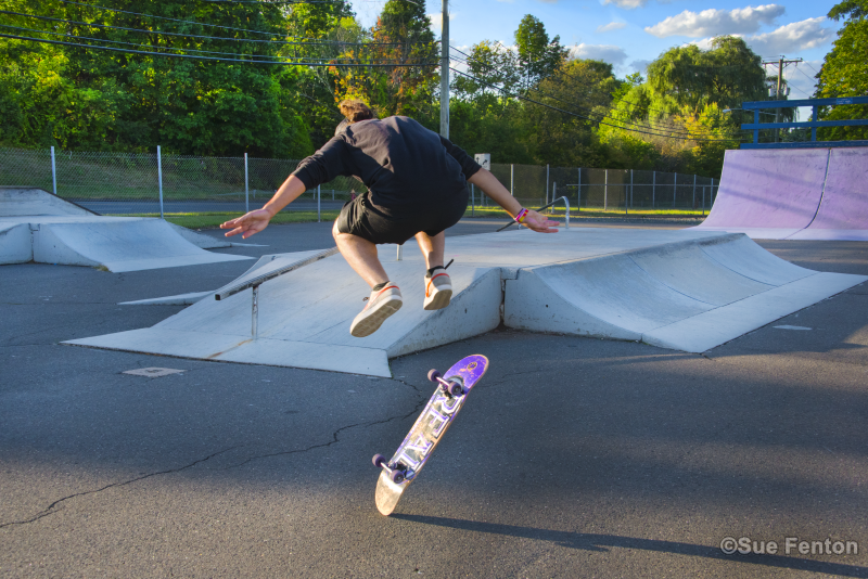Youth doing skateboard trick at skate park