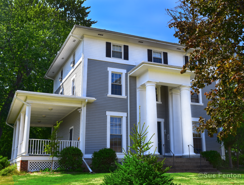 View of house with large while pillars