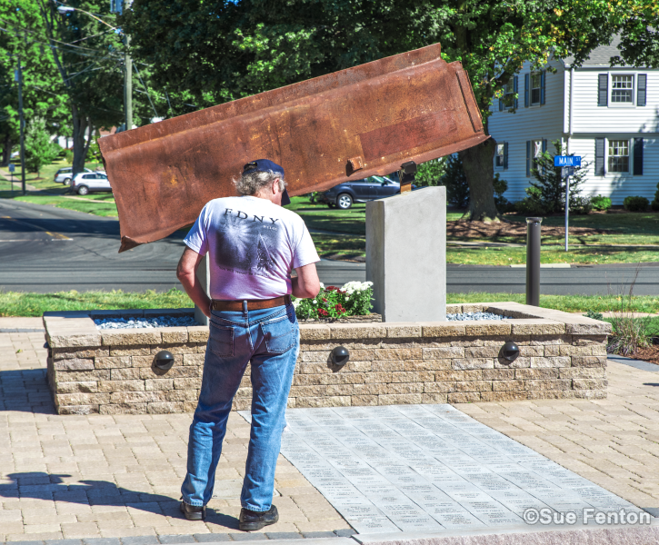 Man standing next to September 11, 2001 Memorial