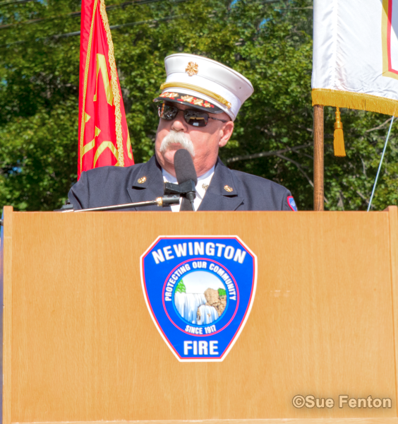 Chief Chris Schroeder standing at lectern during September 11, 2001 Memorial Dedication