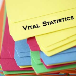 Stack of orange, pink, blue, green and yellow tabbed folders with vital statistics written on top fo