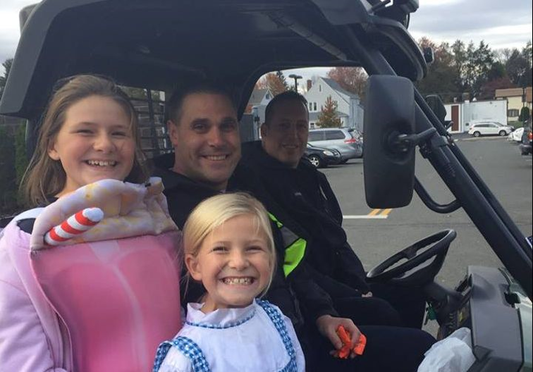 Two Police officer and two children dressed in halloween costumes