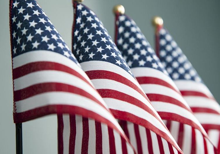 Photograph of four American flags in a row