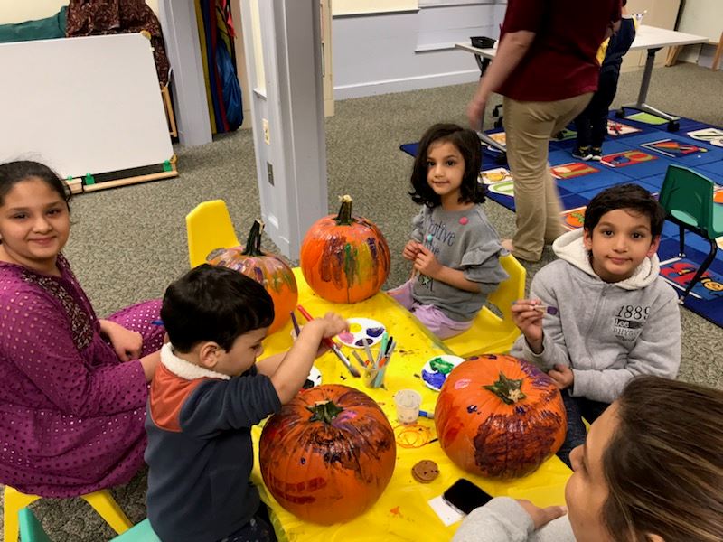 family decorating pumpkins