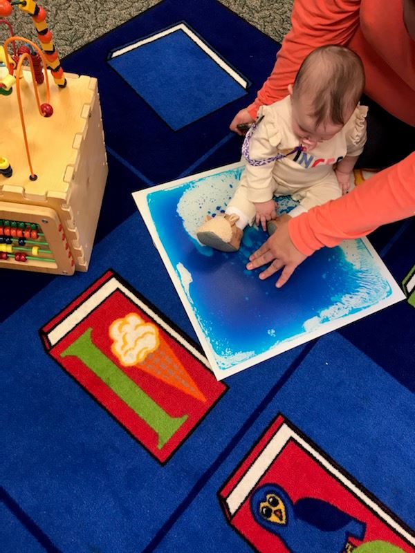 baby sitting on color-changing tile