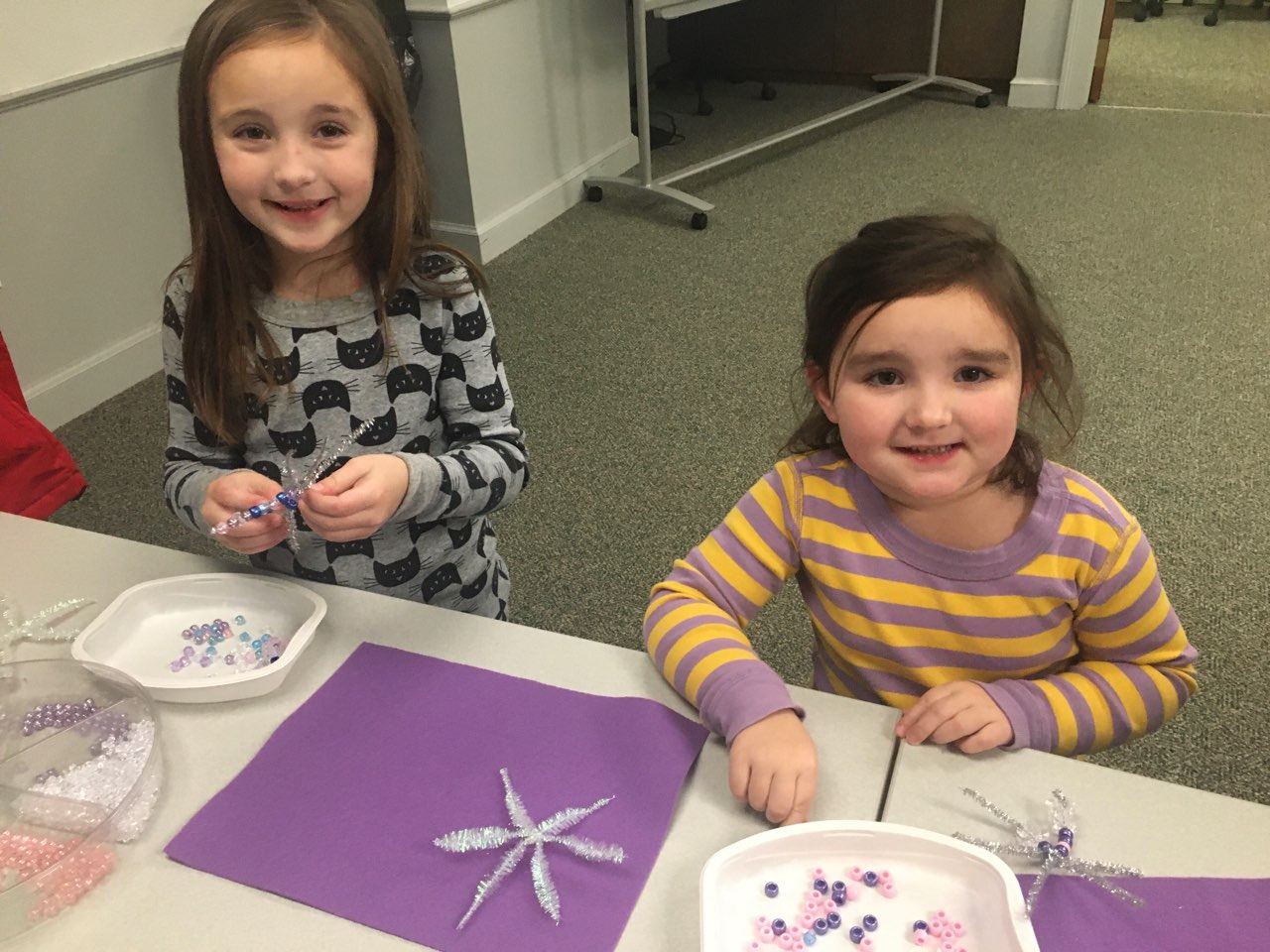 girls making pipe cleaner beaded snowflakes