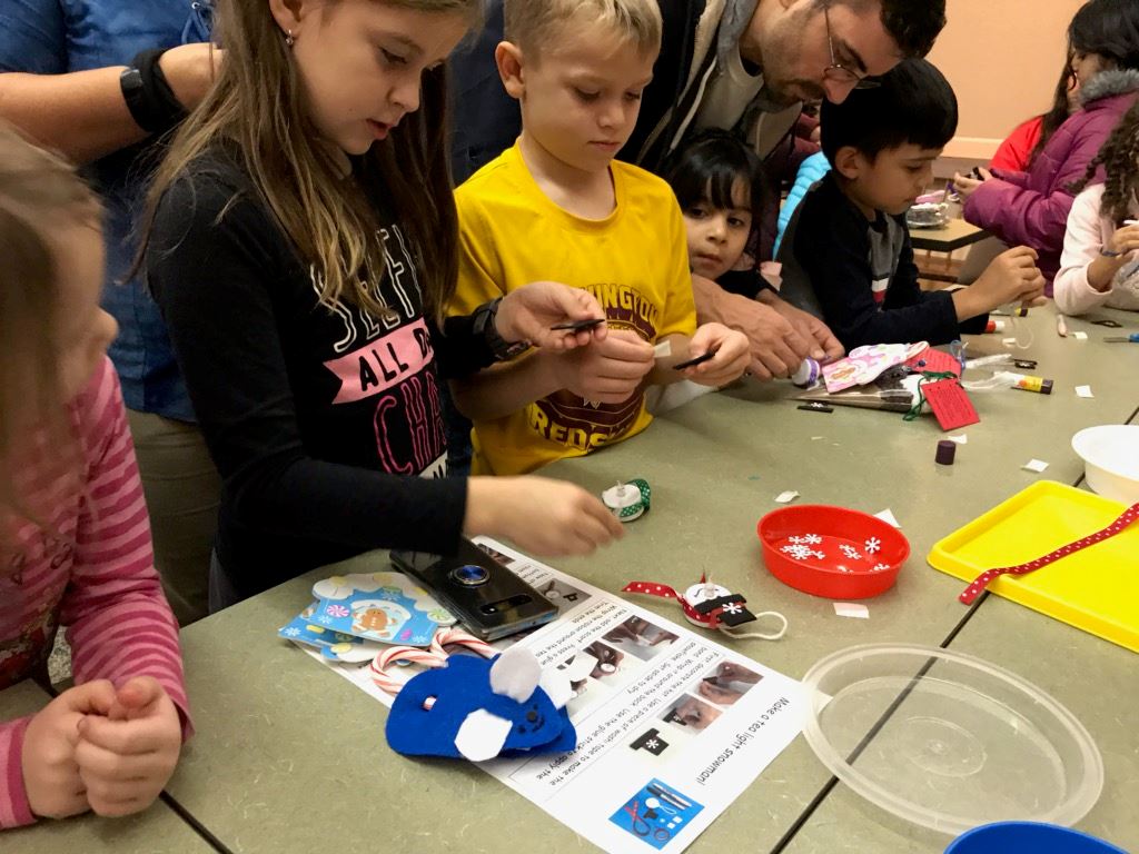 kids making tea light snowman ornaments