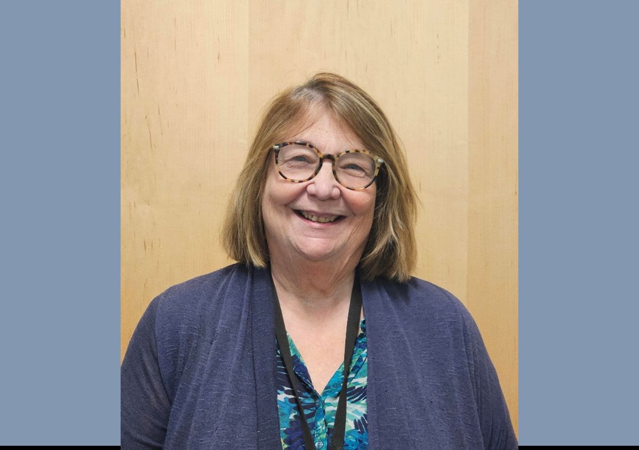 Picture of caucasian woman with shoulder length brown hair and glasses.
