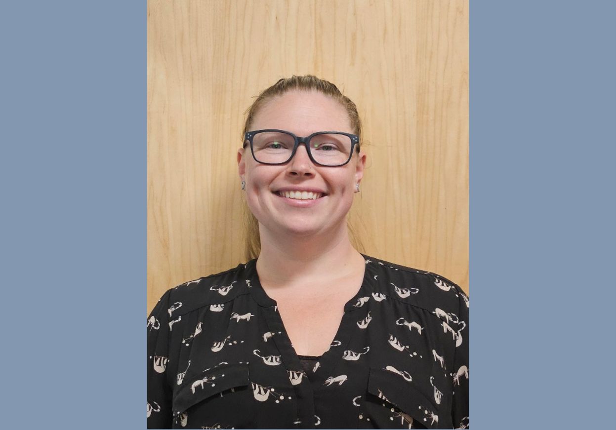 Picture of caucasian woman with blonde hair in a pony tail & glasses.